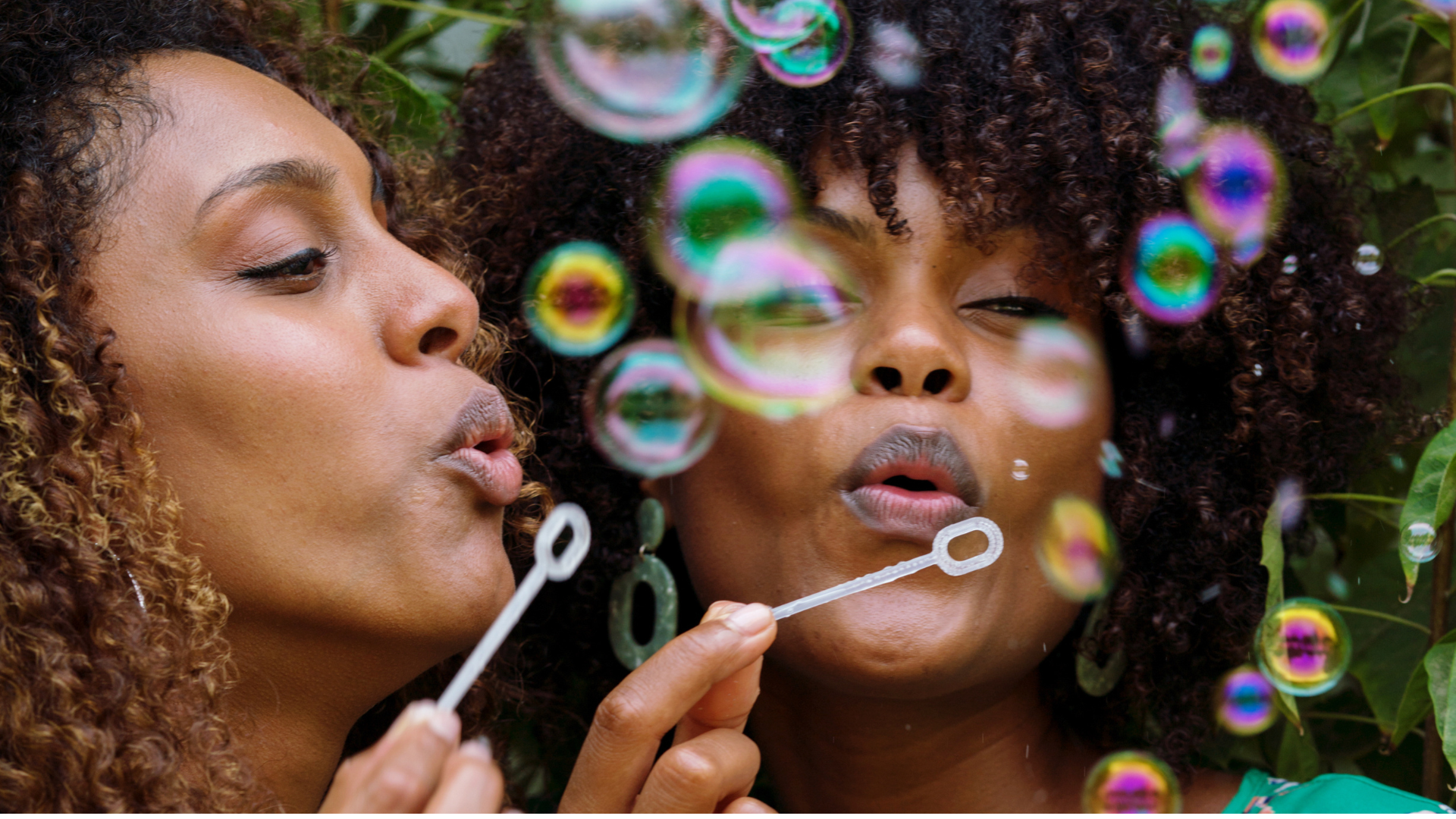 Sister-Friend Retreat — two women blowing bubbles outdoors